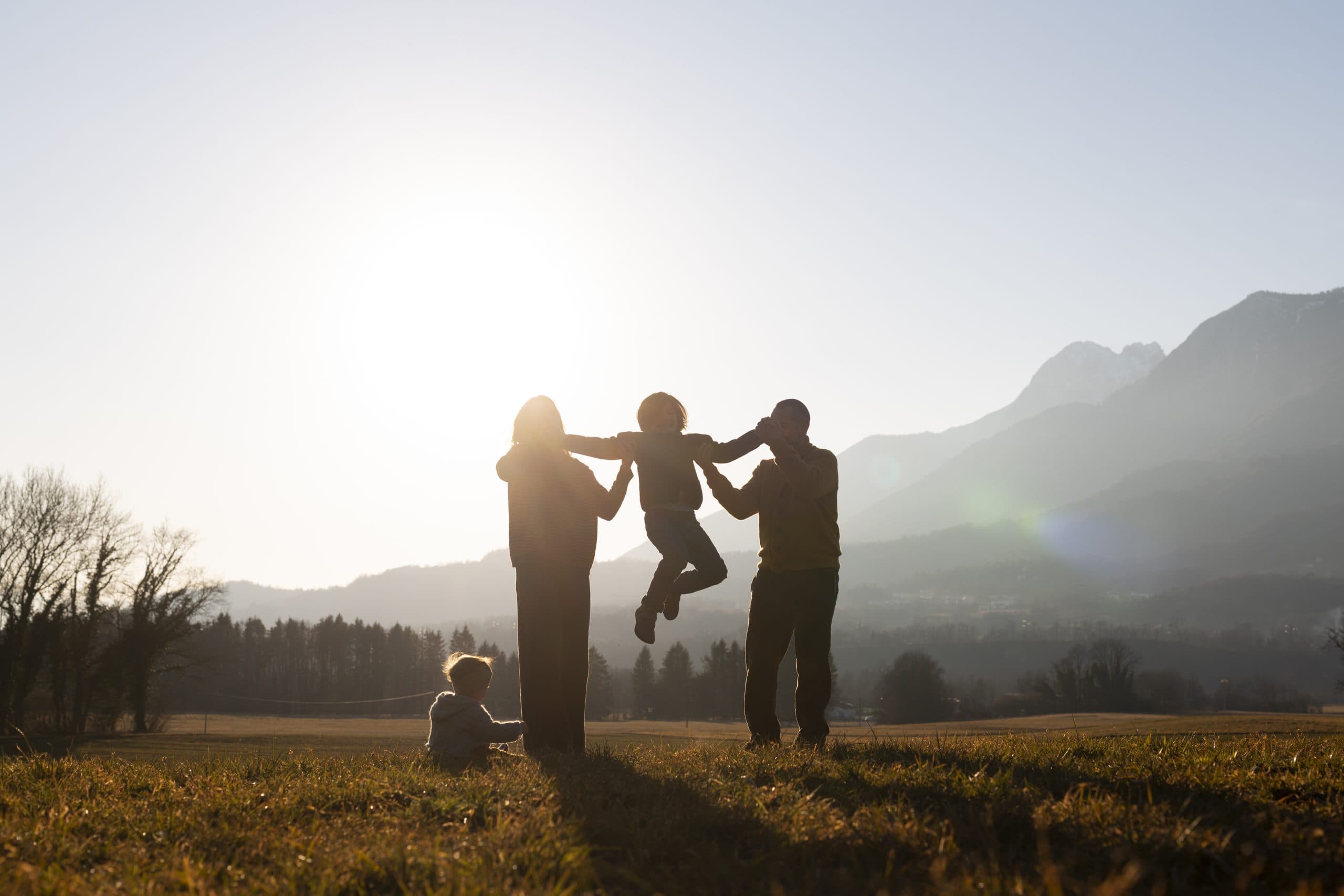 A family enjoying time together outdoors at sunset